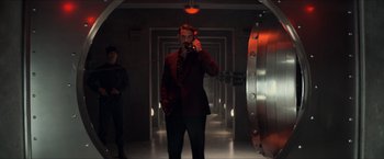 Movie still from “The Man from U.N.C.L.E.” (2015), directed by Guy Ritchie – A man in a suit taking a picture of himself; Wide shot, Low angle