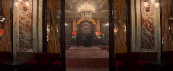 Movie still from “The Man from U.N.C.L.E.” (2015), directed by Guy Ritchie – Two men are standing in front of a large window; Extreme Wide shot, Low angle