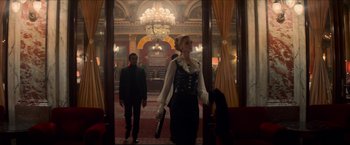 Movie still from “The Man from U.N.C.L.E.” (2015), directed by Guy Ritchie – A man and a woman walking through a lobby; Wide shot, Low angle