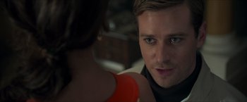 Movie still from “The Man from U.N.C.L.E.” (2015), directed by Guy Ritchie – A person looking at the camera; Close Up shot, Over the shoulder angle