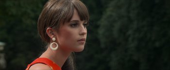 Movie still from “The Man from U.N.C.L.E.” (2015), directed by Guy Ritchie – A person wearing earrings; Close Up shot, Low angle