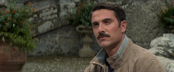Movie still from “The Man from U.N.C.L.E.” (2015), directed by Guy Ritchie – A person with a mustache; Close Up shot, Over the shoulder angle