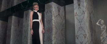Movie still from “The Man from U.N.C.L.E.” (2015), directed by Guy Ritchie – A woman in a black and white dress standing in front of a wall; Medium shot, Low angle