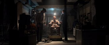 Movie still from “The Man from U.N.C.L.E.” (2015), directed by Guy Ritchie – A man sitting in a chair in the middle of a room; Wide shot, Low angle