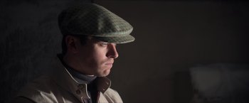 Movie still from “The Man from U.N.C.L.E.” (2015), directed by Guy Ritchie – A man wearing a hat and a jacket; Close Up shot, Low angle