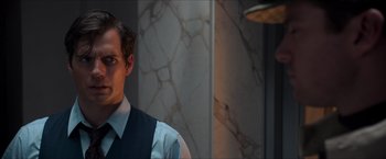 Movie still from “The Man from U.N.C.L.E.” (2015), directed by Guy Ritchie – A man standing in front of a marble wall; Close Up shot, Over the shoulder angle