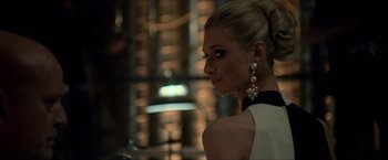 Movie still from “The Man from U.N.C.L.E.” (2015), directed by Guy Ritchie – A beautiful blonde woman wearing a white and black dress; Close Up shot, Over the shoulder angle
