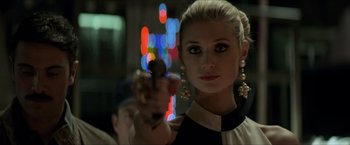 Movie still from “The Man from U.N.C.L.E.” (2015), directed by Guy Ritchie – A beautiful blonde woman holding a gun in her hand; Close Up shot, Over the shoulder angle