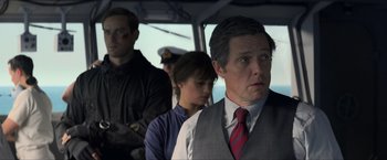 Movie still from “The Man from U.N.C.L.E.” (2015), directed by Guy Ritchie – A man in a suit and tie next to another man in a suit and tie; Medium shot, Over the shoulder angle