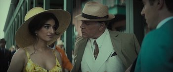 Movie still from “The Many Saints of Newark” (2021), directed by Alan Taylor – A man and a woman wearing hats and a suit; Close Up shot, Low angle