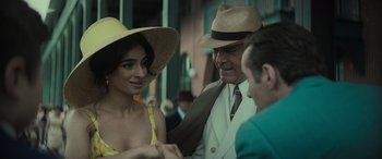 Movie still from “The Many Saints of Newark” (2021), directed by Alan Taylor – A man and a woman talking to a man in a hat; Medium shot, Over the shoulder angle