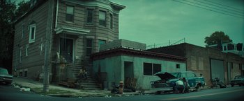 Movie still from “The Many Saints of Newark” (2021), directed by Alan Taylor – An old building with a fire hydrant in front of it; Extreme Wide shot, Low angle