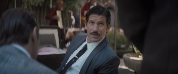 Movie still from “The Many Saints of Newark” (2021), directed by Alan Taylor – A person wearing a suit and tie; Close Up shot, Over the shoulder angle