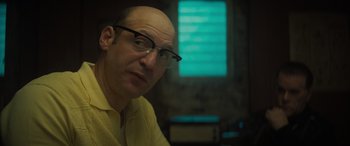 Movie still from “The Many Saints of Newark” (2021), directed by Alan Taylor – A bald man with glasses is looking at the camera; Close Up shot, Low angle