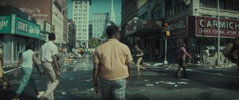 Movie still from “The Many Saints of Newark” (2021), directed by Alan Taylor – A man standing in the middle of a street; Wide shot, Over the shoulder angle