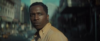 Movie still from “The Many Saints of Newark” (2021), directed by Alan Taylor – A person wearing a yellow shirt; Close Up shot, Low angle