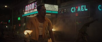 Movie still from “The Many Saints of Newark” (2021), directed by Alan Taylor – A man standing on a street at night; Medium shot, Low angle