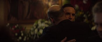 Movie still from “The Many Saints of Newark” (2021), directed by Alan Taylor – A man hugging another man in front of flowers; Close Up shot, Over the shoulder angle
