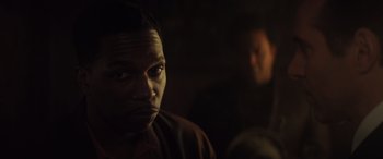 Movie still from “The Many Saints of Newark” (2021), directed by Alan Taylor – A person in a dark room; Close Up shot, Over the shoulder angle
