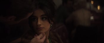 Movie still from “The Many Saints of Newark” (2021), directed by Alan Taylor – A beautiful woman with dark hair and a green necklace; Close Up shot, Over the shoulder angle