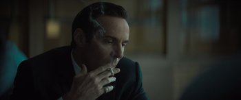 Movie still from “The Many Saints of Newark” (2021), directed by Alan Taylor – A person smoking a cigarette; Close Up shot, Over the shoulder angle