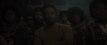 Movie still from “The Many Saints of Newark” (2021), directed by Alan Taylor – A group of men standing in front of each other in a room; Medium shot, Low angle