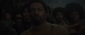 Movie still from “The Many Saints of Newark” (2021), directed by Alan Taylor – A man in a sweater looking up at the sky; Close Up shot, Low angle