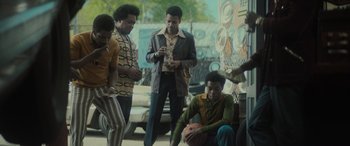 Movie still from “The Many Saints of Newark” (2021), directed by Alan Taylor – A group of men standing next to each other on a street; Wide shot, Low angle