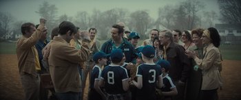 Movie still from “The Many Saints of Newark” (2021), directed by Alan Taylor – A group of young men standing next to each other on a baseball field; Medium shot, Over the shoulder angle