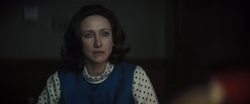 Movie still from “The Many Saints of Newark” (2021), directed by Alan Taylor – A woman in a blue polka dot shirt looking at the camera; Close Up shot, Over the shoulder angle