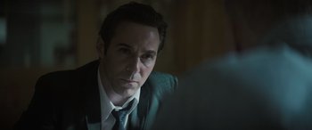 Movie still from “The Many Saints of Newark” (2021), directed by Alan Taylor – A person wearing a suit and tie; Close Up shot, Over the shoulder angle