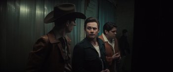 Movie still from “The Many Saints of Newark” (2021), directed by Alan Taylor – A group of men standing next to each other in a room; Medium shot, Over the shoulder angle