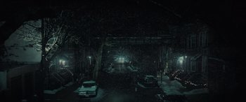 Movie still from “The Many Saints of Newark” (2021), directed by Alan Taylor – Cars parked on the side of the road in the snow at night; Extreme Wide shot, High angle