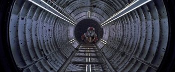 Movie still from “The Martian” (2015), directed by Ridley Scott – A person is standing in a tunnel looking up; Wide shot, Overhead angle