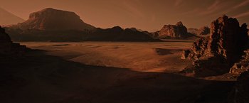Movie still from “The Martian” (2015), directed by Ridley Scott – A desert landscape with mountains in the background; Extreme Wide shot, High angle