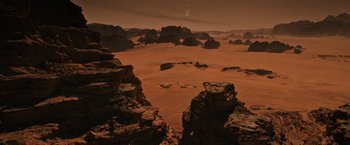 Movie still from “The Martian” (2015), directed by Ridley Scott – A view of some rocks and sand on the desert; Extreme Wide shot, High angle