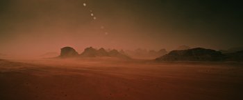 Movie still from “The Martian” (2015), directed by Ridley Scott – A desert landscape with mountains in the background; Extreme Wide shot, High angle