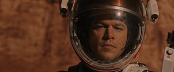 Movie still from “The Martian” (2015), directed by Ridley Scott – A person wearing a space helmet; Close Up shot, Overhead angle