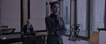 Movie still from “The Martian” (2015), directed by Ridley Scott – A woman in a suit standing in front of a window; Medium shot, Over the shoulder angle