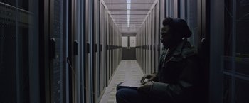 Movie still from “The Martian” (2015), directed by Ridley Scott – A man sitting in a room with a computer; Medium shot, Overhead angle