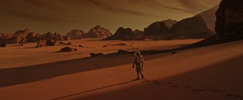 Movie still from “The Martian” (2015), directed by Ridley Scott – An astronaut is walking on the surface of the red planet; Extreme Wide shot, High angle