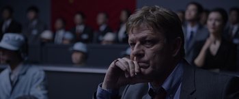 Movie still from “The Martian” (2015), directed by Ridley Scott – A person wearing a suit and tie; Close Up shot, Over the shoulder angle