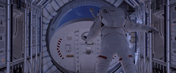 Movie still from “The Martian” (2015), directed by Ridley Scott – A person in a spacesuit climbing up the side of a space ship; Wide shot, Overhead angle