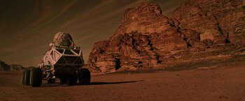 Movie still from “The Martian” (2015), directed by Ridley Scott – An image of a vehicle on a dirt road in the desert; Extreme Wide shot, Low angle