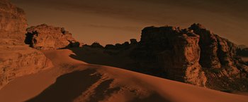 Movie still from “The Martian” (2015), directed by Ridley Scott – A view of a mountain range with a snow covered hill in the foreground; Extreme Wide shot, High angle