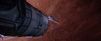 Movie still from “The Martian” (2015), directed by Ridley Scott – An image of an astronaut on a space station in space; Extreme Wide shot, Overhead angle