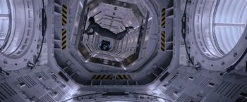 Movie still from “The Martian” (2015), directed by Ridley Scott – A man is hanging upside down in a space station; Wide shot, Overhead angle