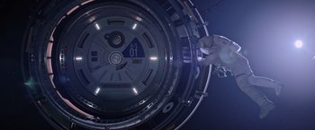 Movie still from “The Martian” (2015), directed by Ridley Scott – A person standing inside of a space station; Wide shot, Overhead angle