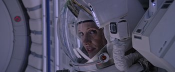 Movie still from “The Martian” (2015), directed by Ridley Scott – A woman in a spacesuit looking into a mirror; Close Up shot, Overhead angle