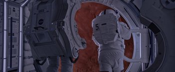 Movie still from “The Martian” (2015), directed by Ridley Scott – An image of an astronaut in a spacesuit in space; Wide shot, Overhead angle